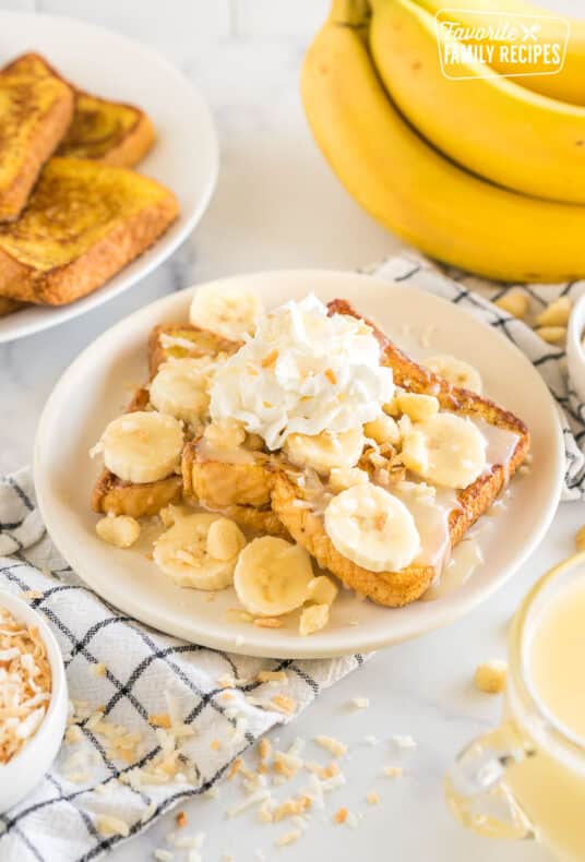 French toast topped with bananas, coconut flakes, coconut syrup, whipped cream, and macadamia nuts