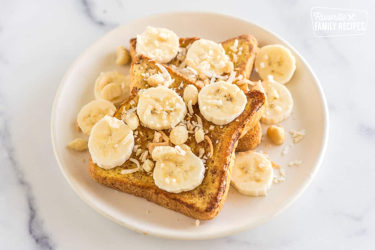 French toast topped with bananas, coconut flakes, and macadamia nuts