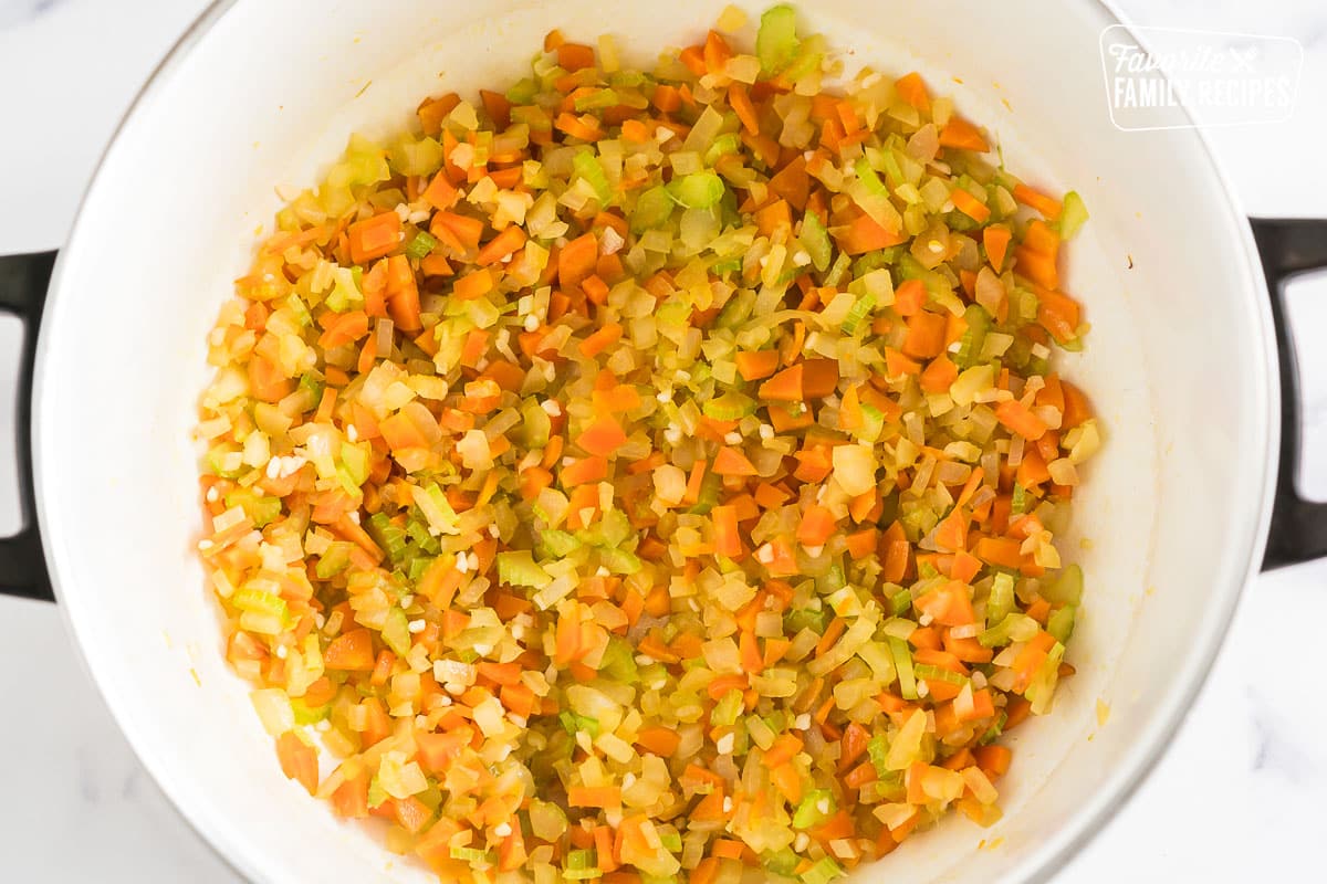Celery, onion, carrots, and garlic cooked in a pot