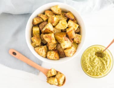 A bowl and spoonful of pesto potatoes