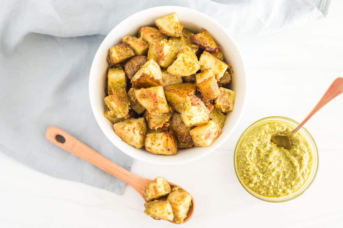 A bowl and spoonful of pesto potatoes