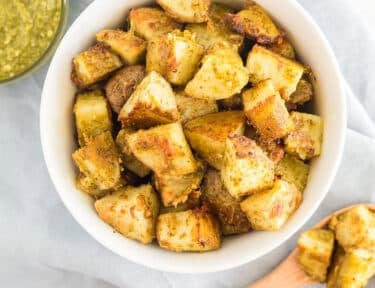 A bowl and spoonful of pesto potatoes