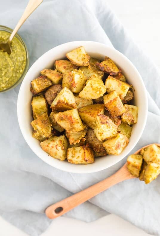 A bowl and spoonful of pesto potatoes