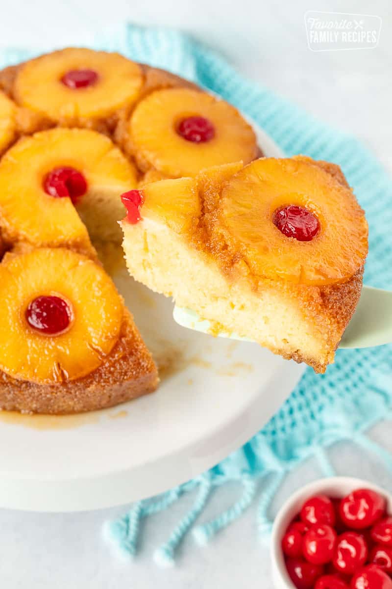 Spatula with a slice of Pineapple Upside Down Cake on the cake stand.