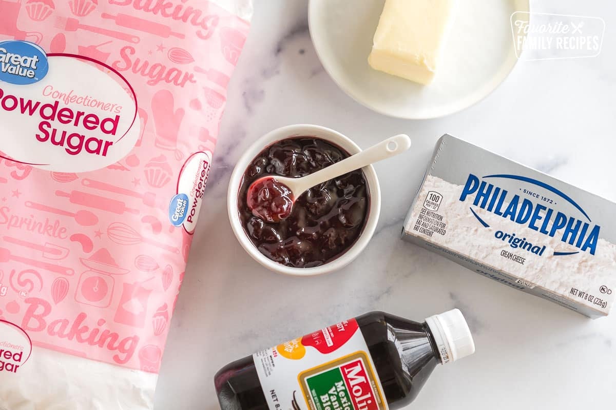 Powdered Sugar, jam, cream cheese, vanilla, and butter on the counter top