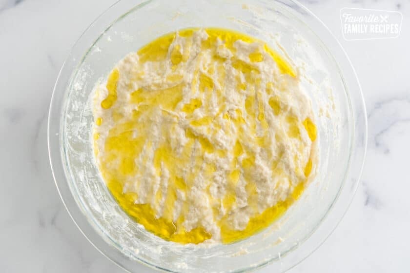 dough in a bowl drizzled with olive oil