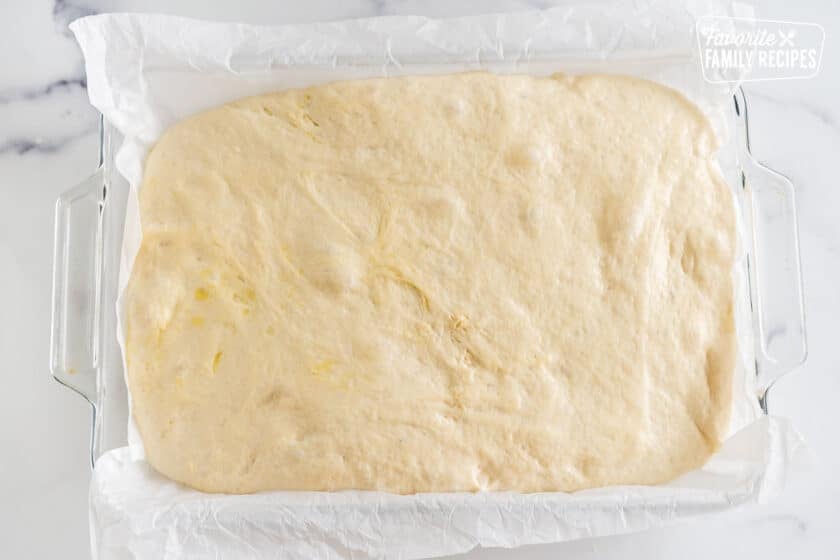 Risen, bubbly dough in a 9x13 pan