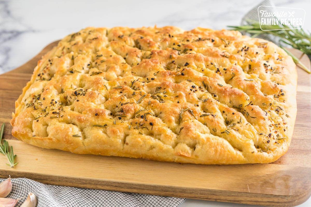 A loaf of Rosemary Garlic Focaccia Bread on a cutting board