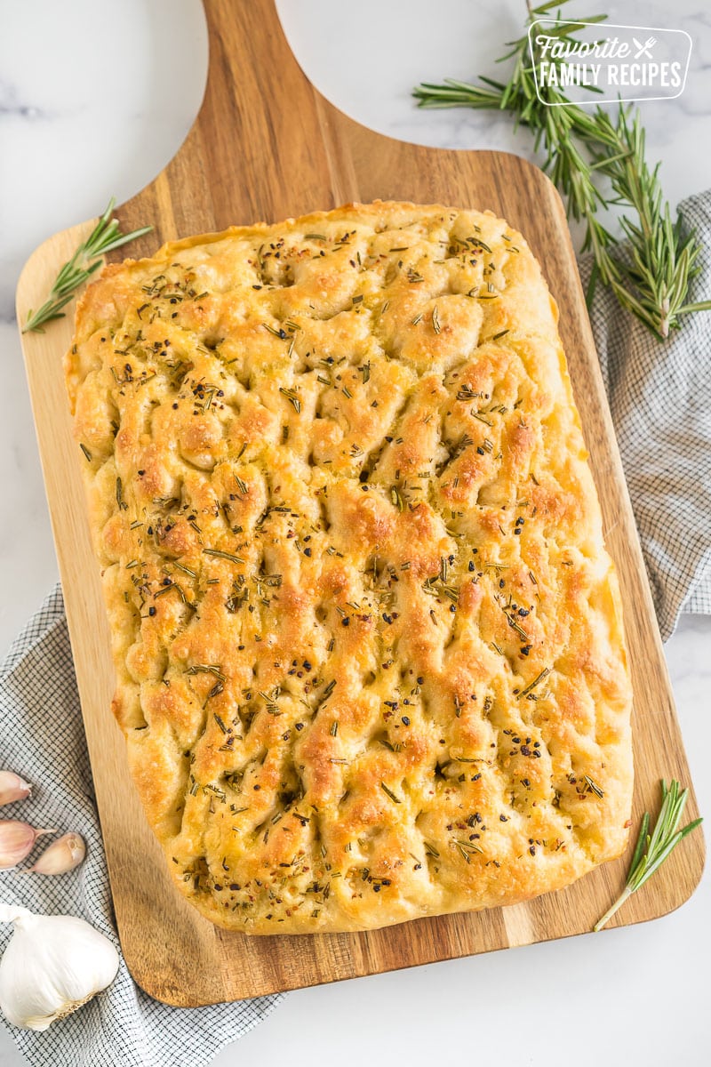 A loaf of Rosemary Garlic Focaccia Bread on a cutting board