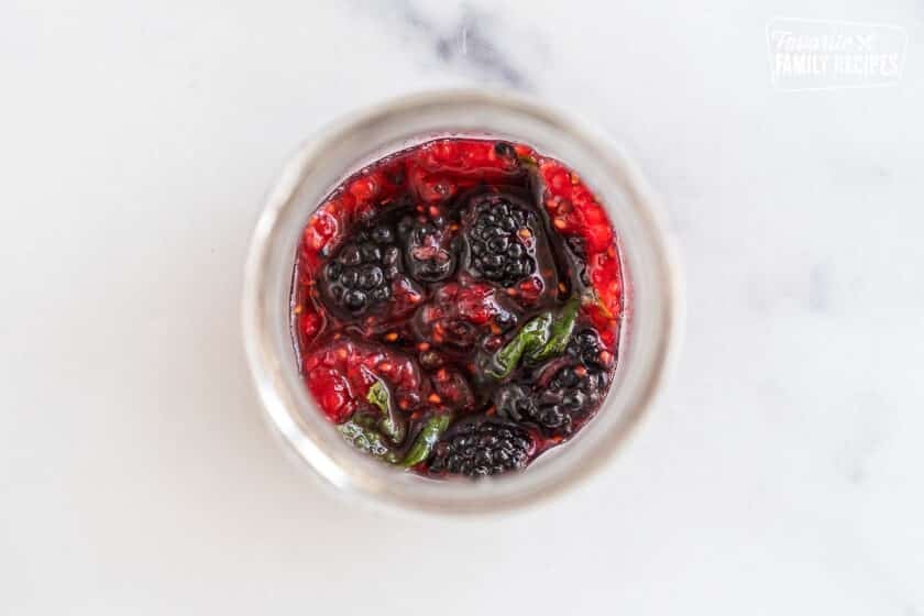 raspberries, blackberries, mint, lime, and sugar muddled in a cup