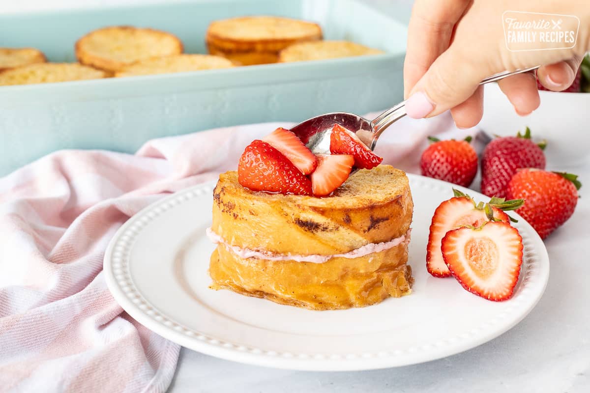 Topping Strawberry French Toast with Strawberries.