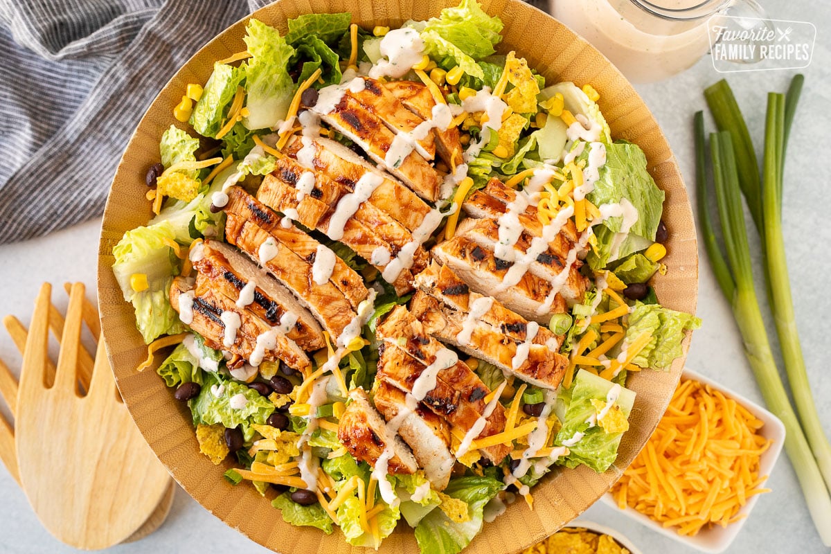 Close up of Barbecue Chicken Salad in a bowl with dressing on top.