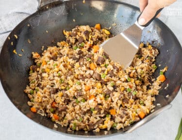 Scooping Steak Fried Rice out of wok.