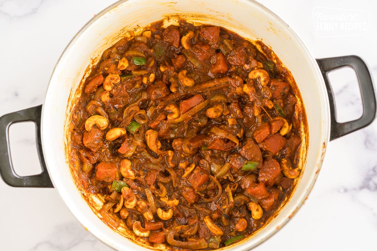 Sauteed veggies, spices, and nuts in a pot