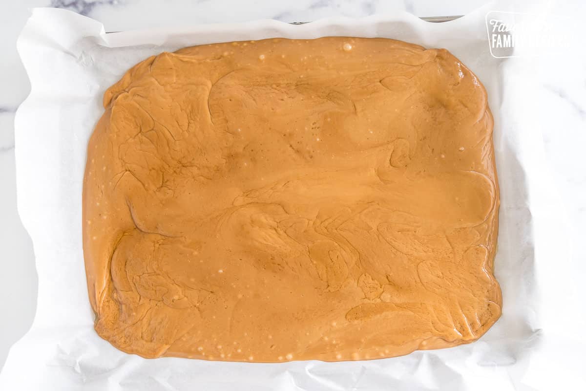 Toffee spread out on a parchment lined baking sheet