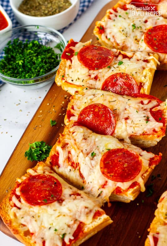 Cut slices of French Bread Pizza on a cutting board.