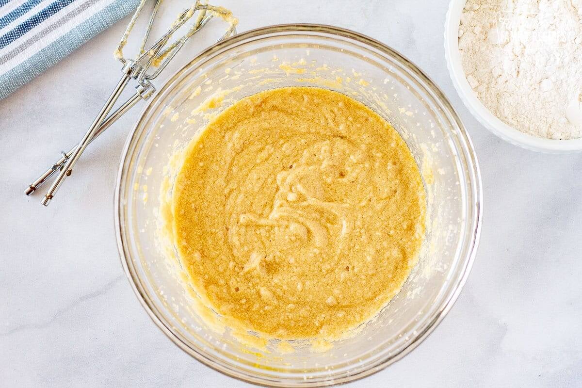 Mixing bowl with mixture of sugar, butter, vanilla and eggs to make the dough for easy fruit pizza.