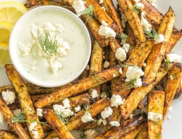 Greek Fries with feta dip on a plate