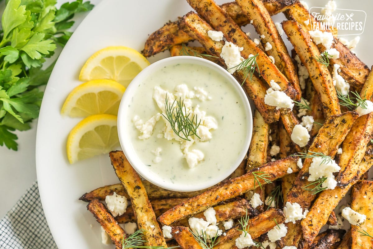 Greek Fries with feta dip on a plate