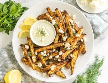 Greek Fries with feta dip on a plate