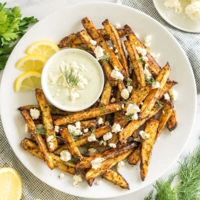 Greek Fries with feta dip on a plate