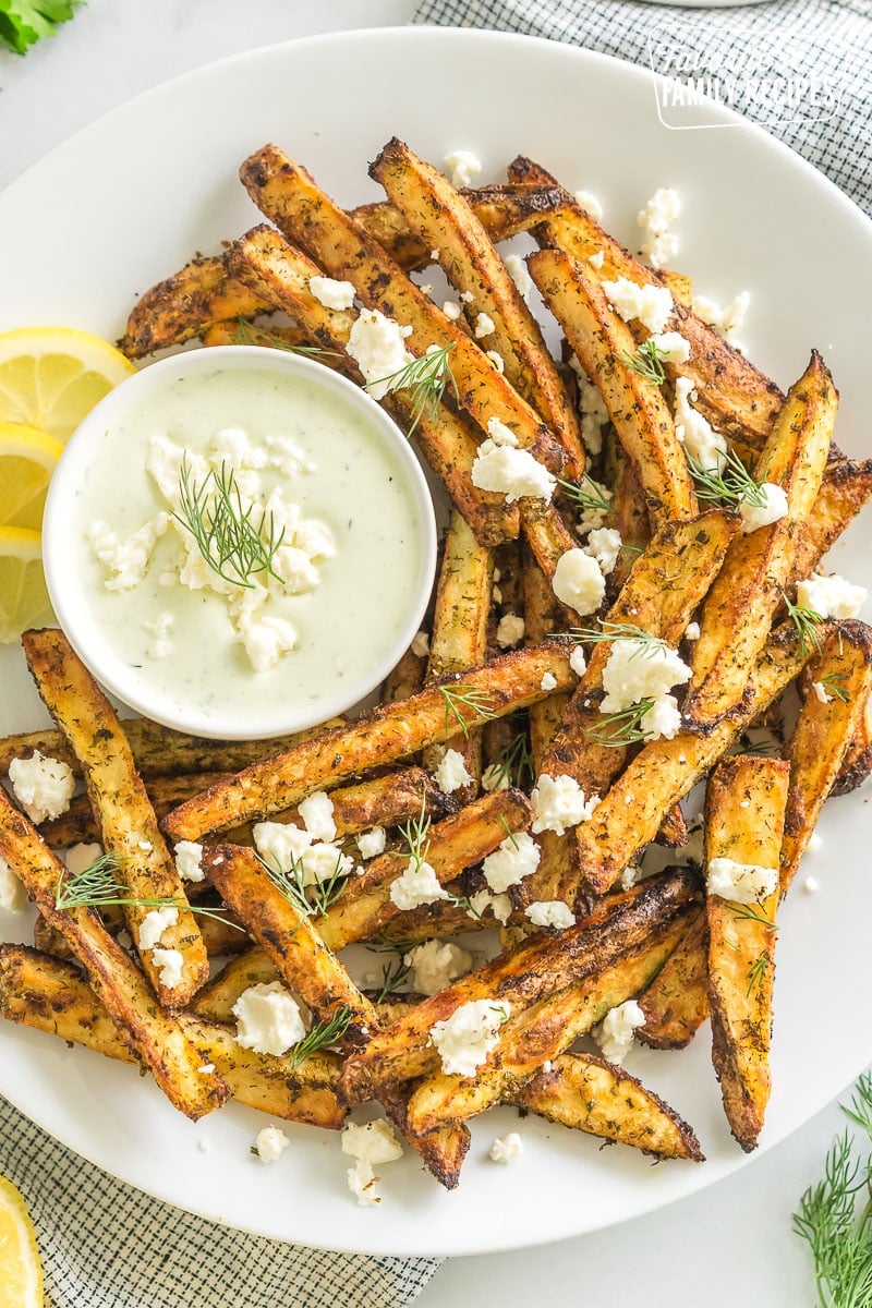 Greek Fries with feta dip on a plate