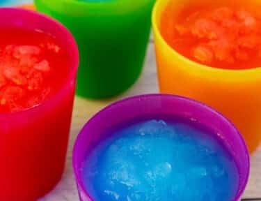 Cups of blue and pink slushie.