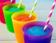 Blue and pink slushie in cups with colorful straws.