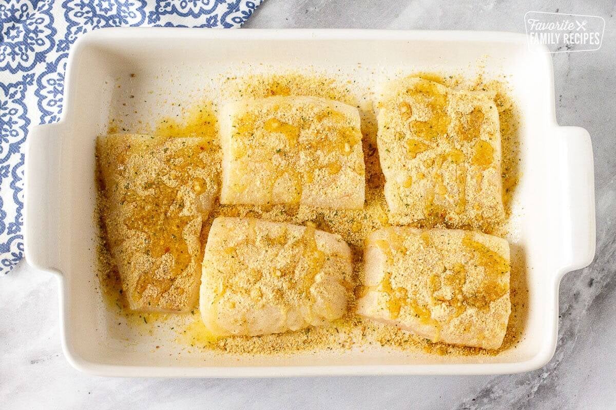 Baking dish with cod fish topped with bread crumb mixture and butter.