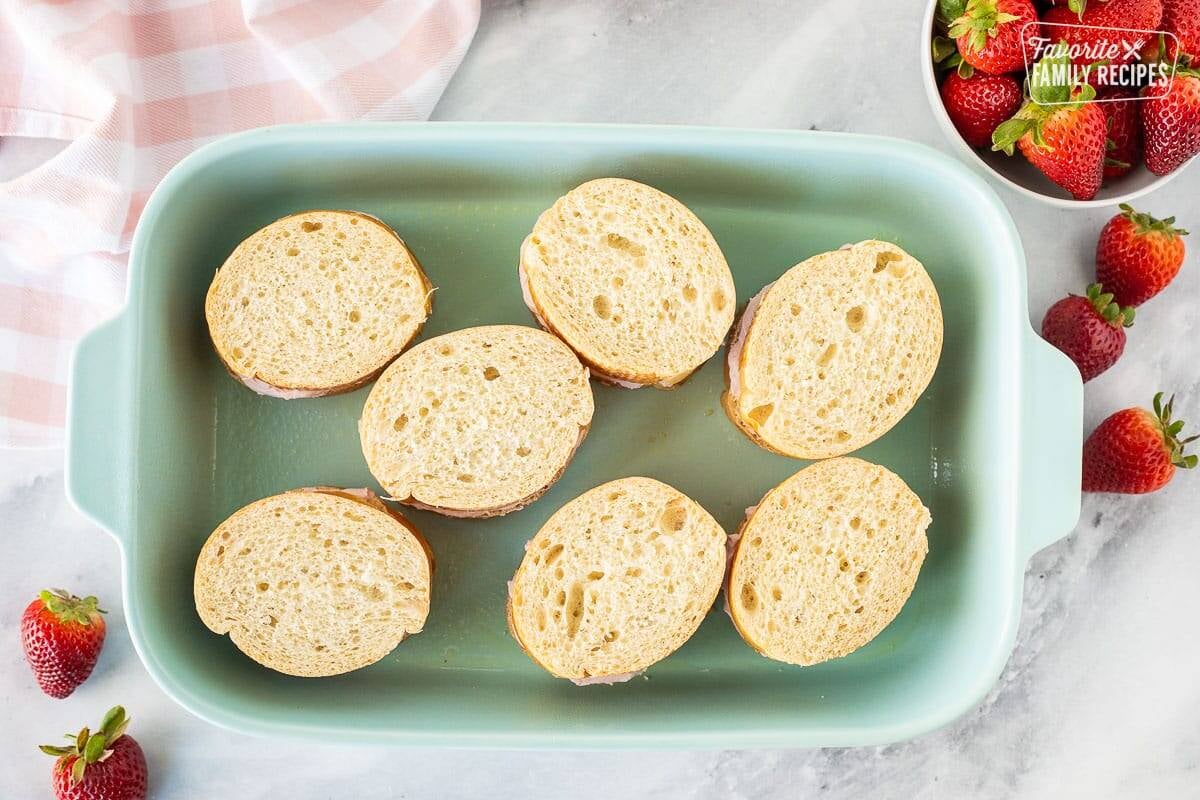 Baking dish with assembled pieces of Strawberry French Toast.