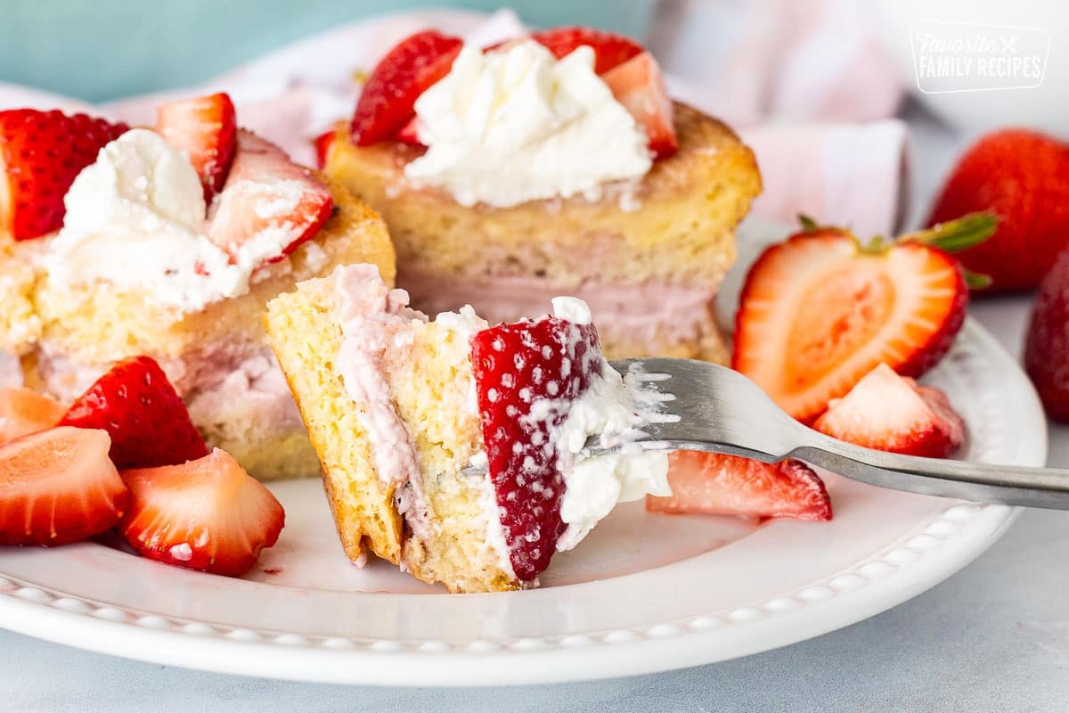 Fork in a bite of Strawberry French Toast resting on a plate.
