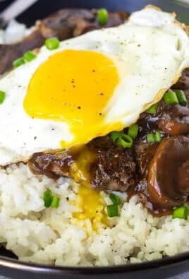 Close up of a bowl with Loco Moco topped with green onion.