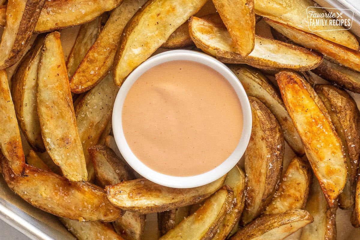 Sheet of fries with bowl of Fry Sauce in the middle.
