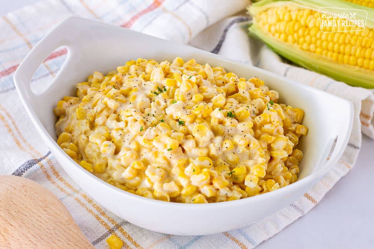 Bowl of Creamed Corn garnished with parsley.