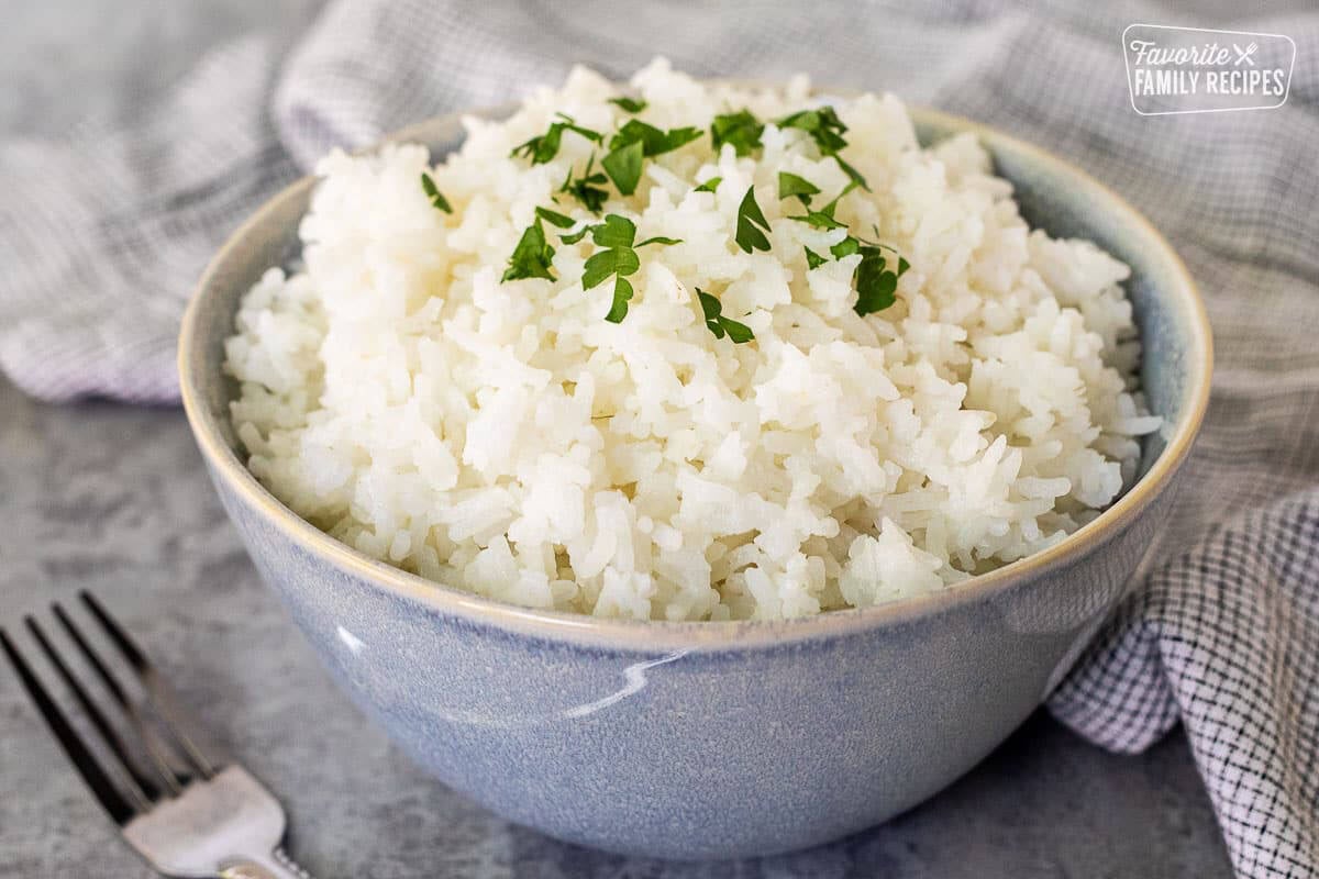 Bowl of Long Grain Rice topped with parsley for garnish.