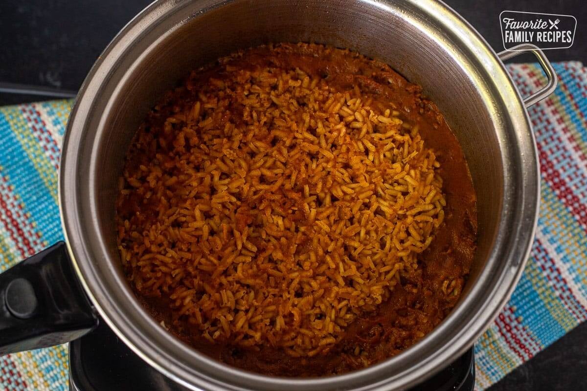 Cooked Mexican rice after it has been browned, seasoned, and simmered in a pot.