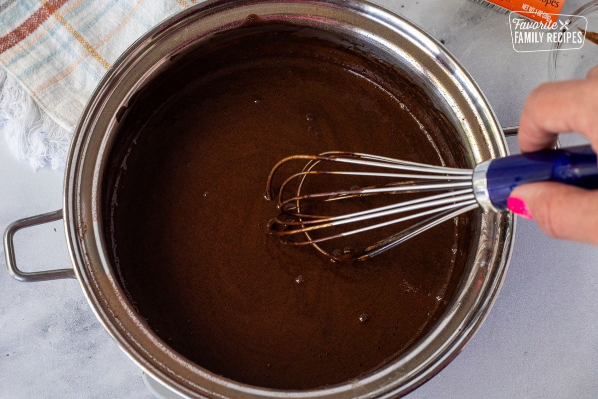 Whisked together chocolate ingredients in a pan for Chocolate Satin Pie filling.