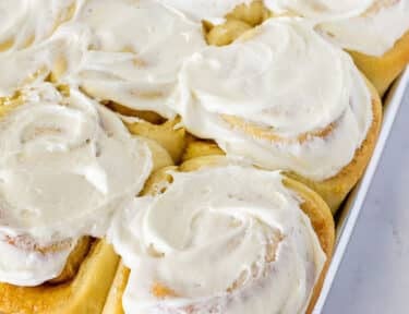 Baked Homemade cinnamon rolls with frosting on top.