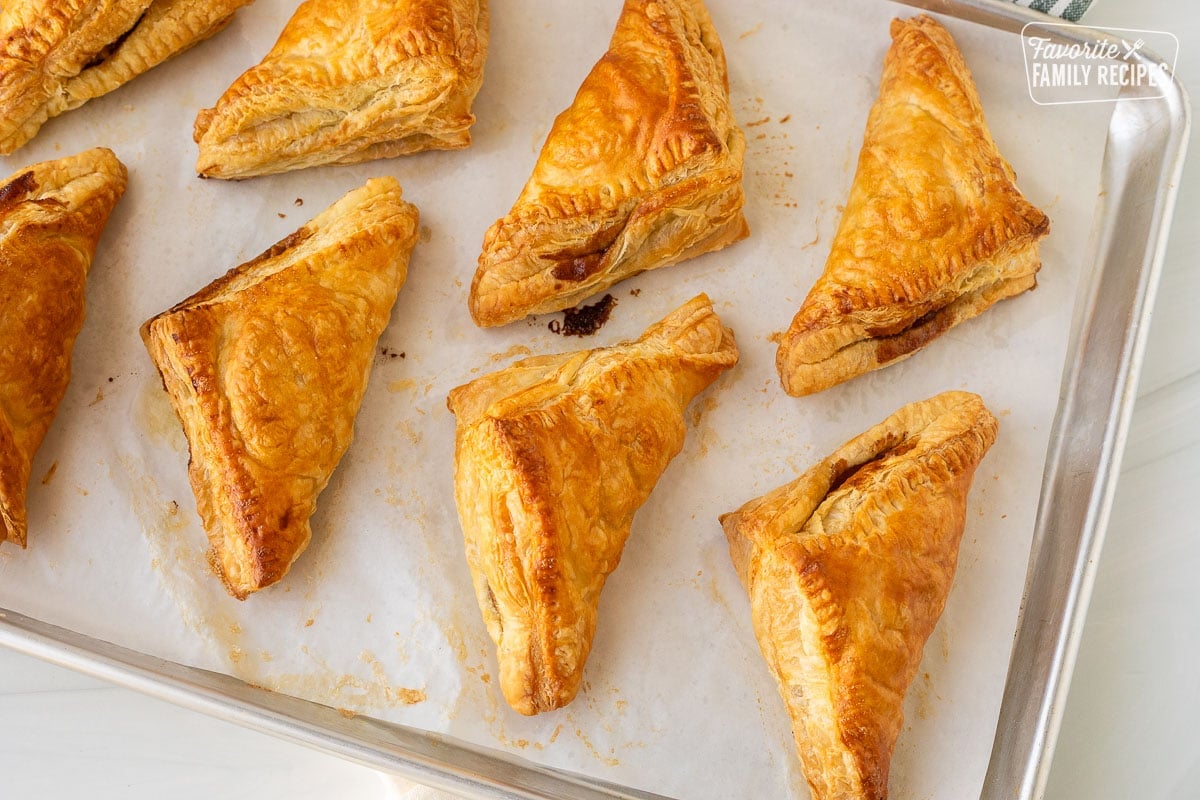 Baked Apple Turnovers on a baking sheet lined with parchment paper.