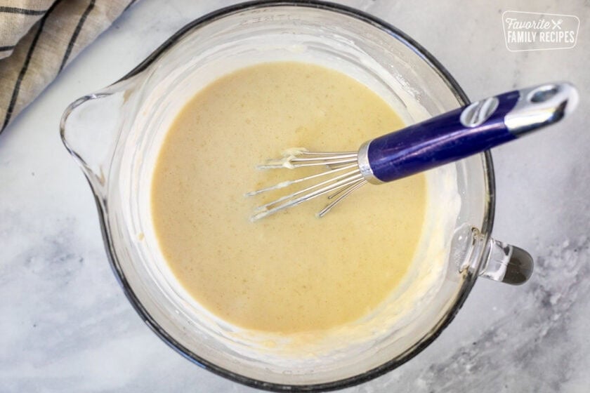 Mixing bowl with batter base and a whisk.