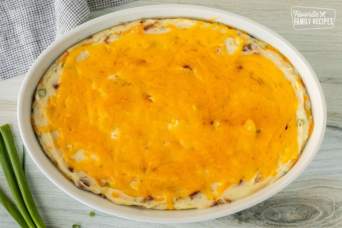 Melted cheese on top of Loaded Mashed Potatoes.