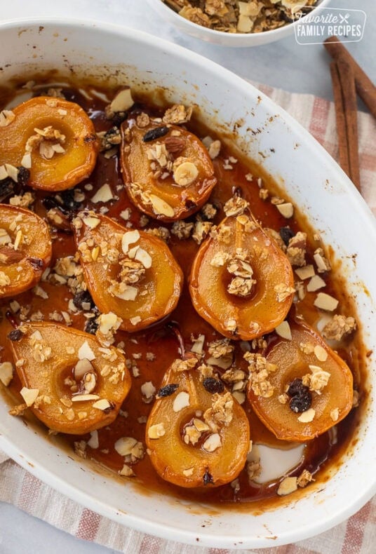 Baking dish of baked pears, topped with granola.