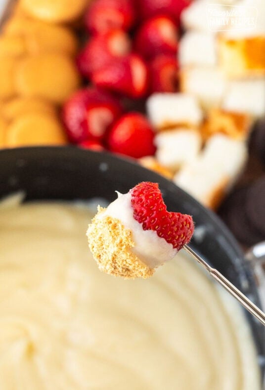 Strawberry on a skewer dipped in Cheesecake Fondue.