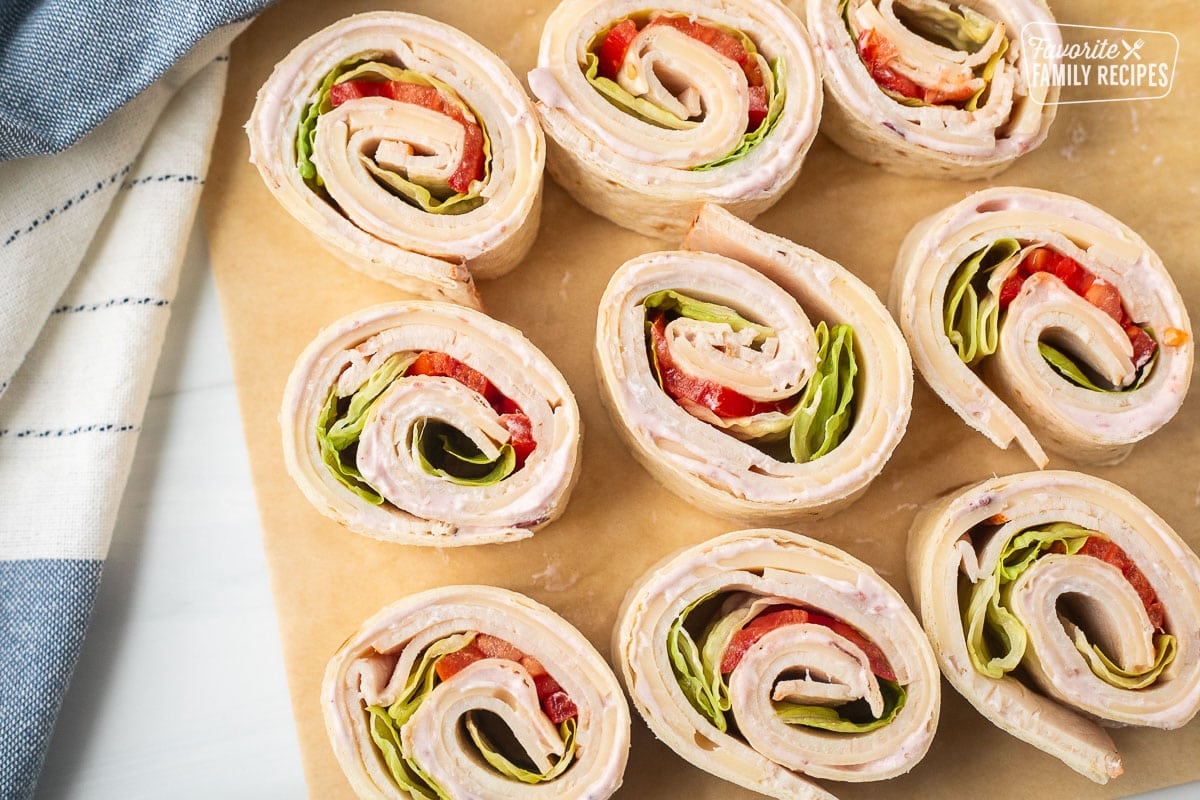 Turkey roll ups filled with cranberry cream cheese, turkey slices, Swiss cheese, tomatoes and lettuce.