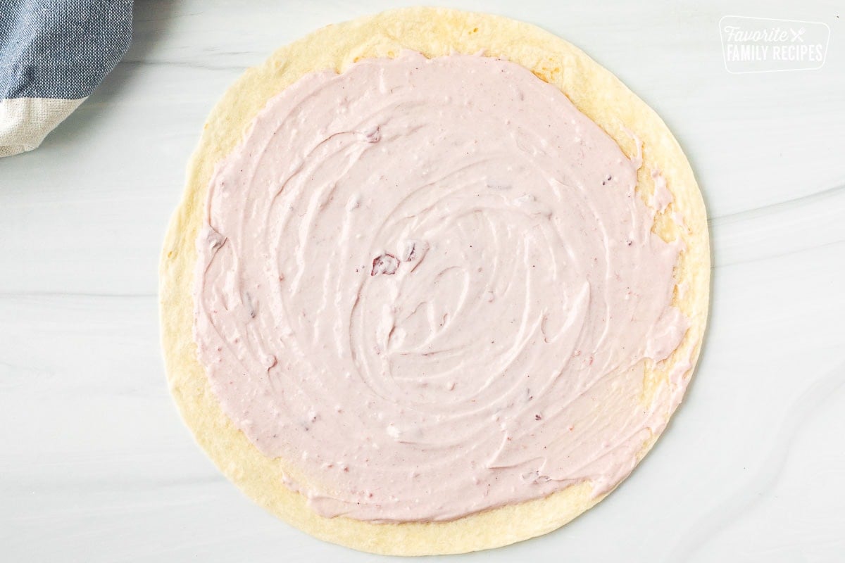 Flour tortilla with cranberry cream cheese spread on top.
