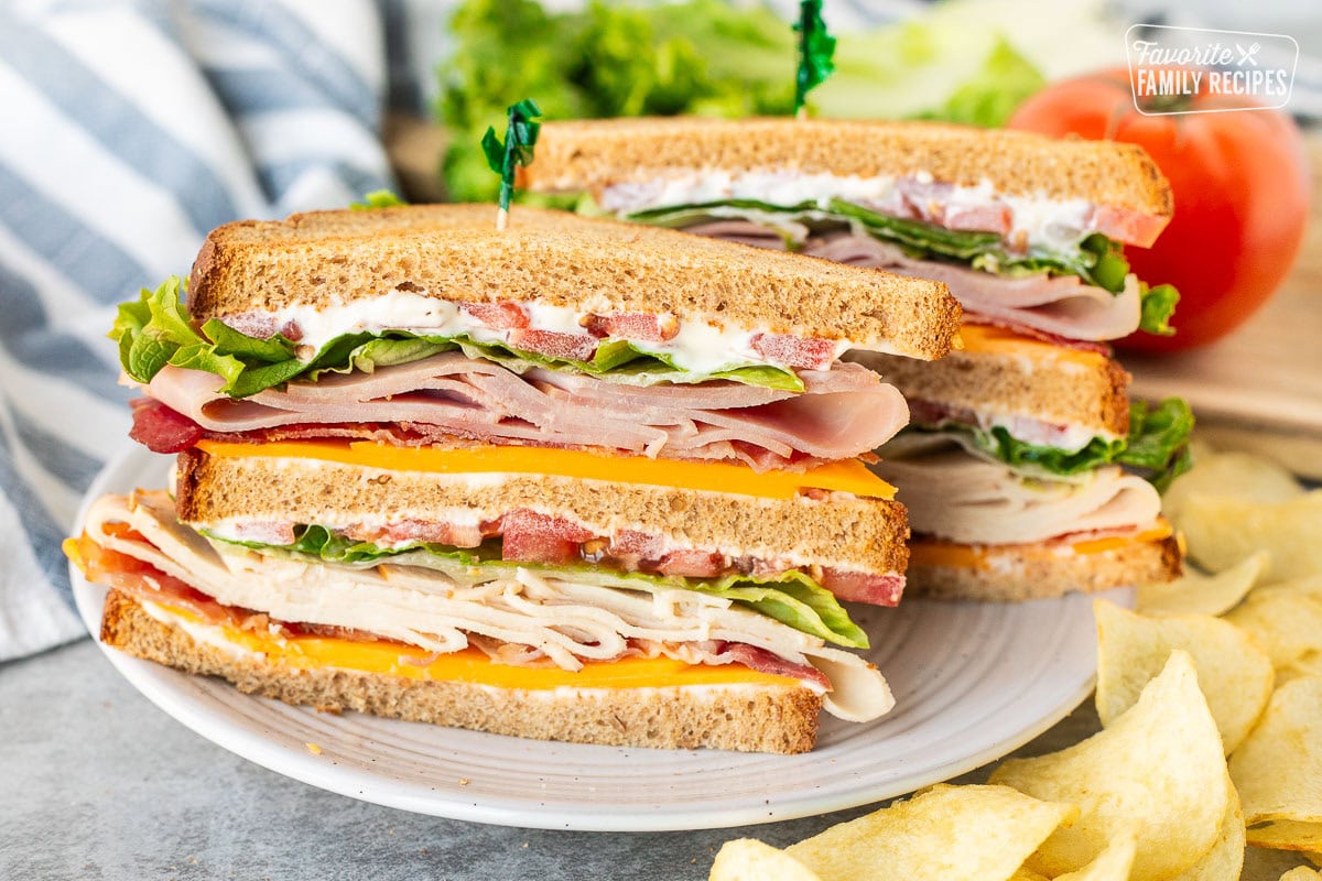 Triple Decker club sandwich with wheat bread sliced in half.