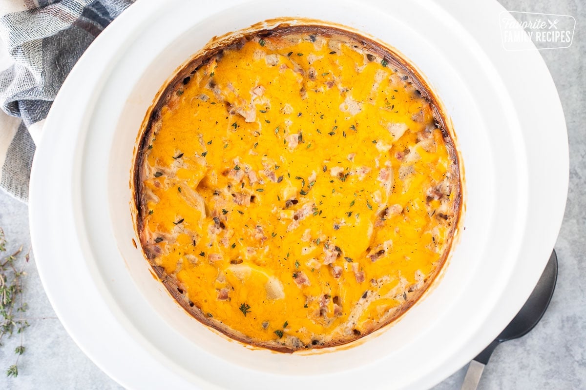 Cooked scalloped potatoes and ham in a crockpot.