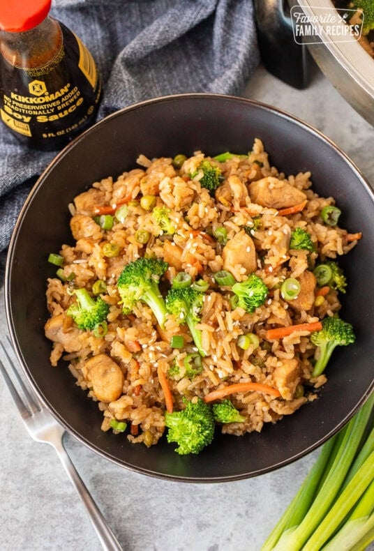 One Pot Teriyaki Chicken Bowls with rice, carrots, green onions, broccoli and sesame seeds.