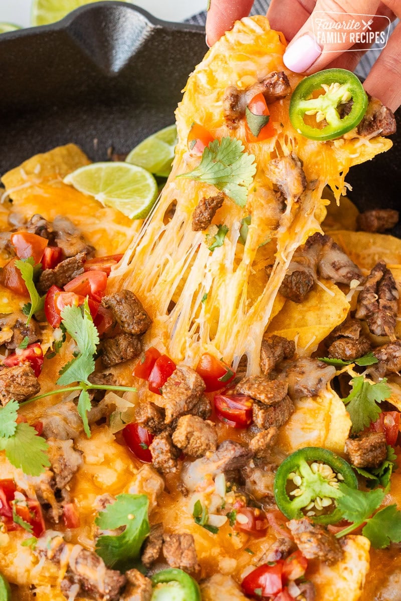 Picking up a cheesy Carne Asada nacho chip.