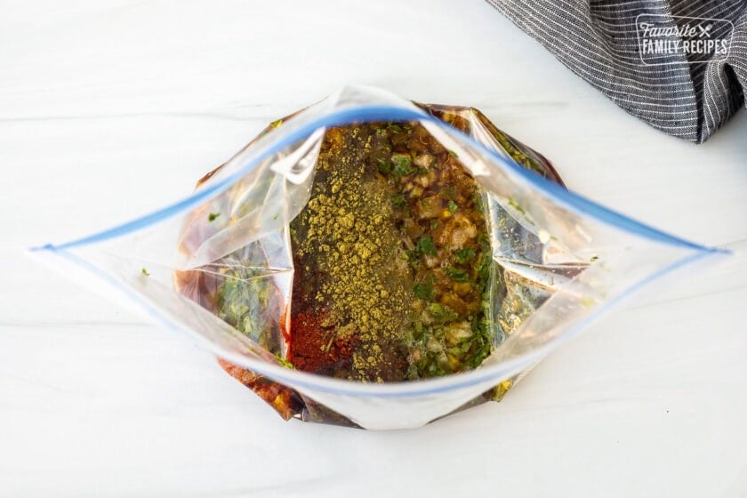 Carne asada marinade ingredients in a plastic bag for grilled carne asada.